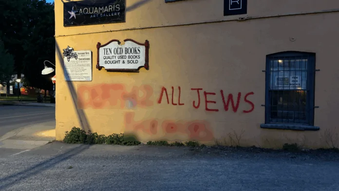 Blurred photo of spraypainted hate speech on a building in Duncan, B.C.